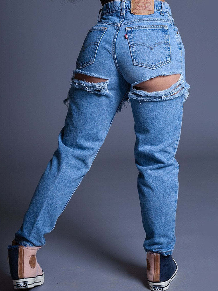 Vaqueros ajustados con cortes rasgados en denim